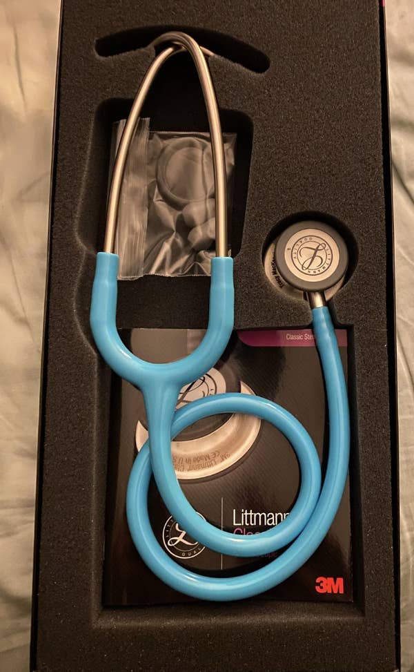 A teal stethoscope lies on a textured surface; text celebrates it as a birthday gift