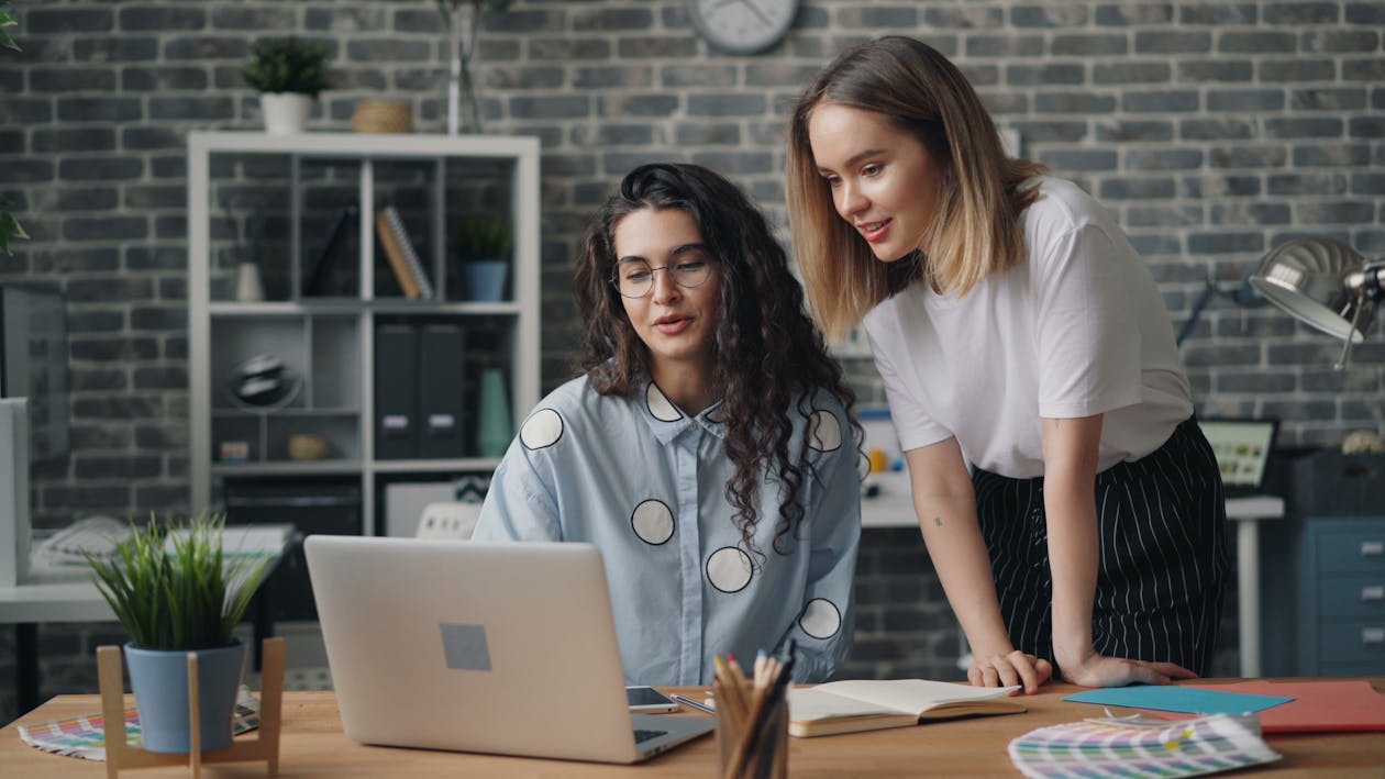 Free Two women working on a laptop in an office Stock Photo